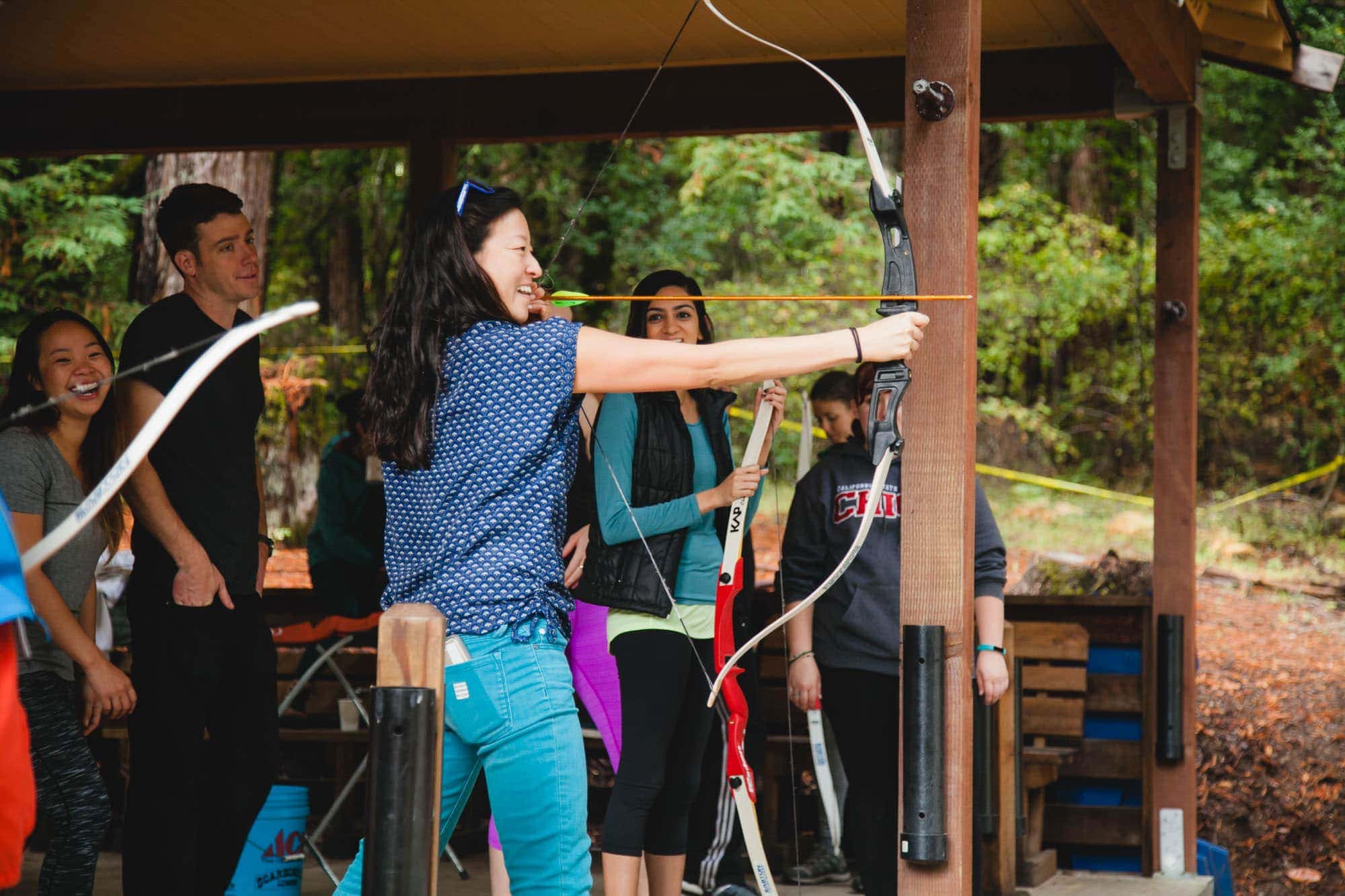woman doing archery at YMCA camp campbell