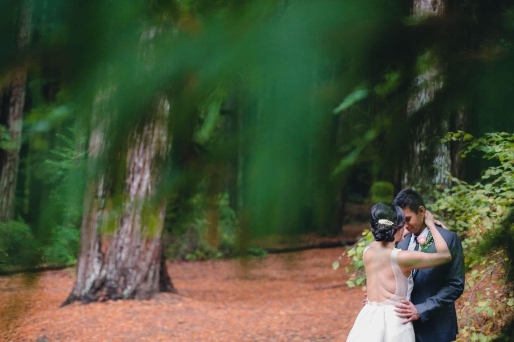 Wedding couple hugging in the woods