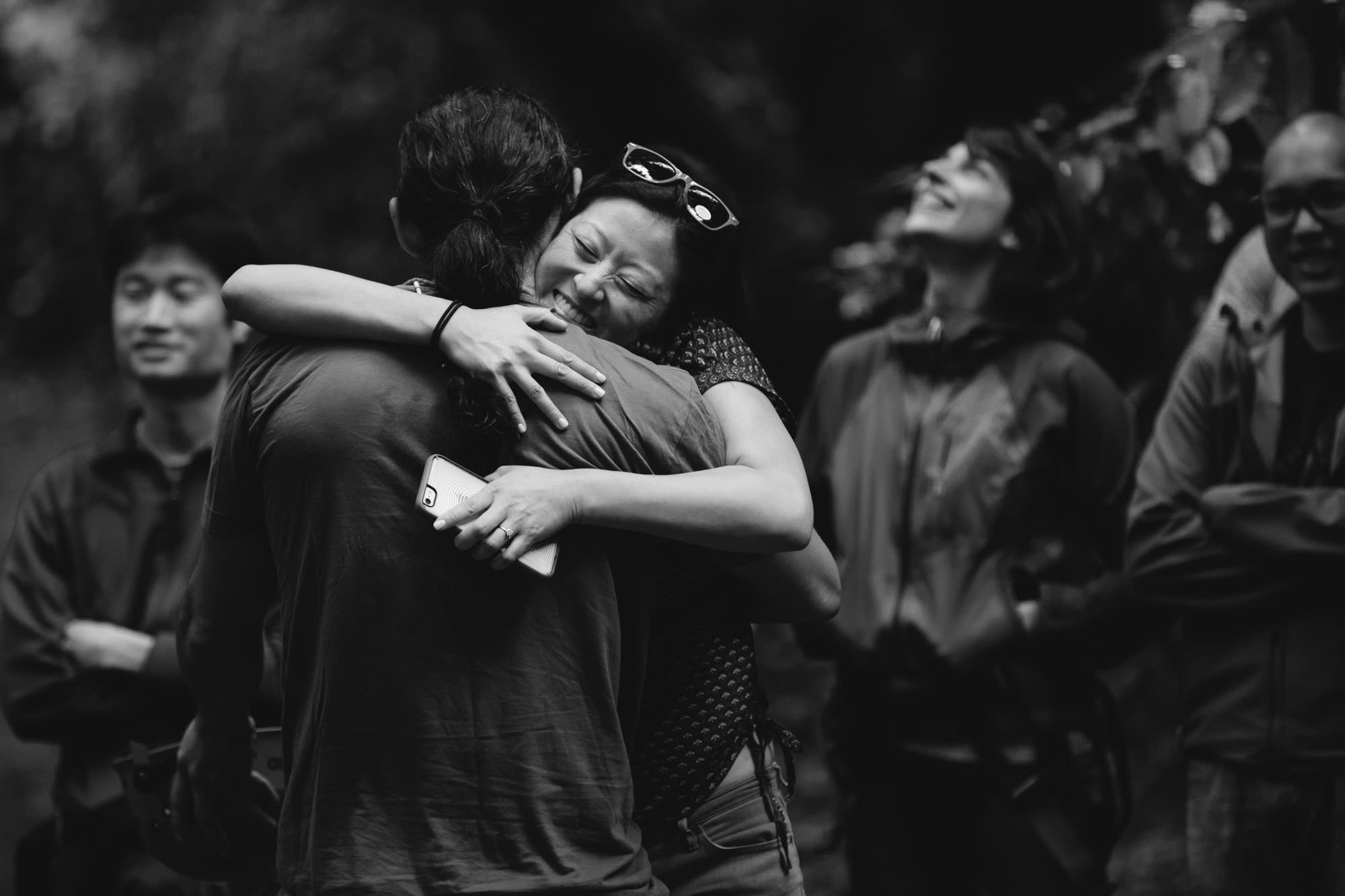 black and white image of people hugging