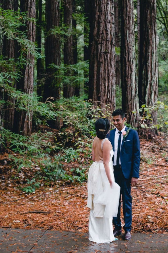 Bride and groom looking at each other on a path in the redwoods
