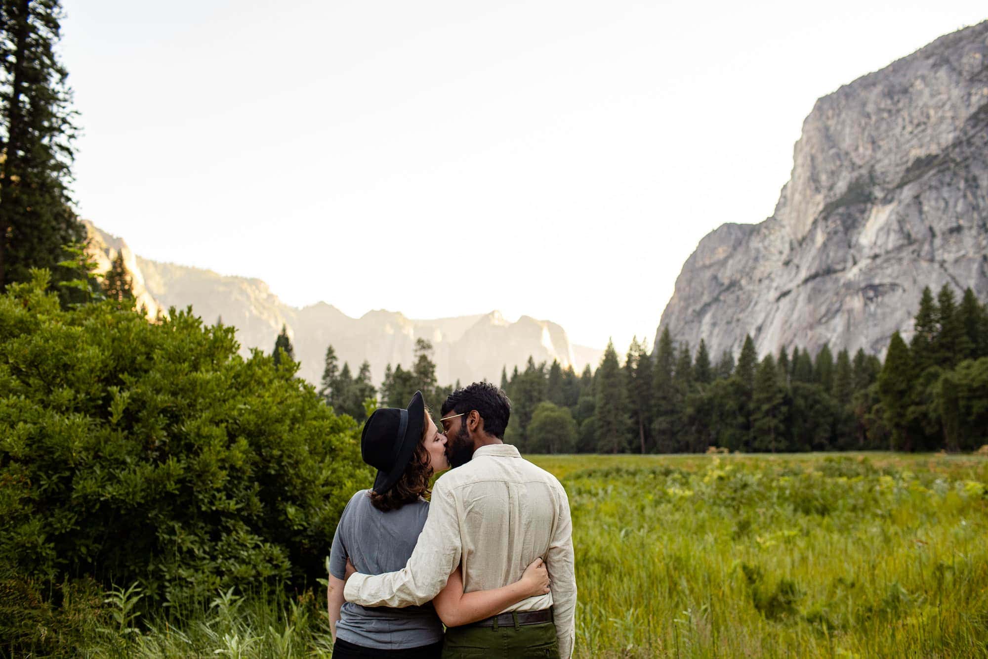 Couple standing in Yosemite Valley kissing