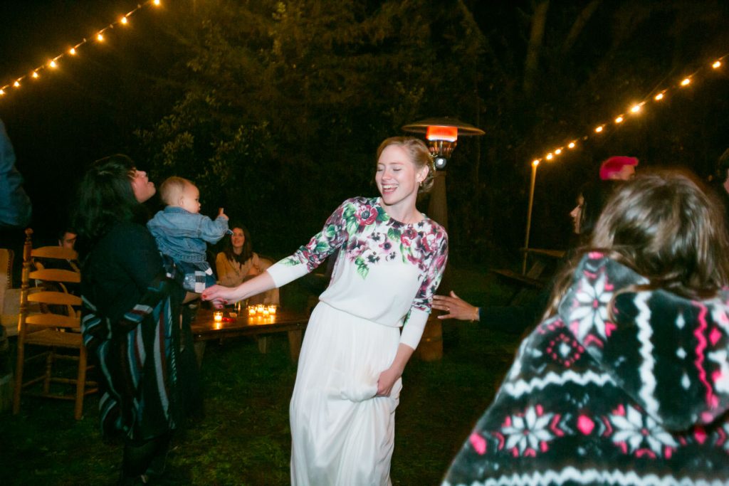 Bride dancing at wedding reception outside at night