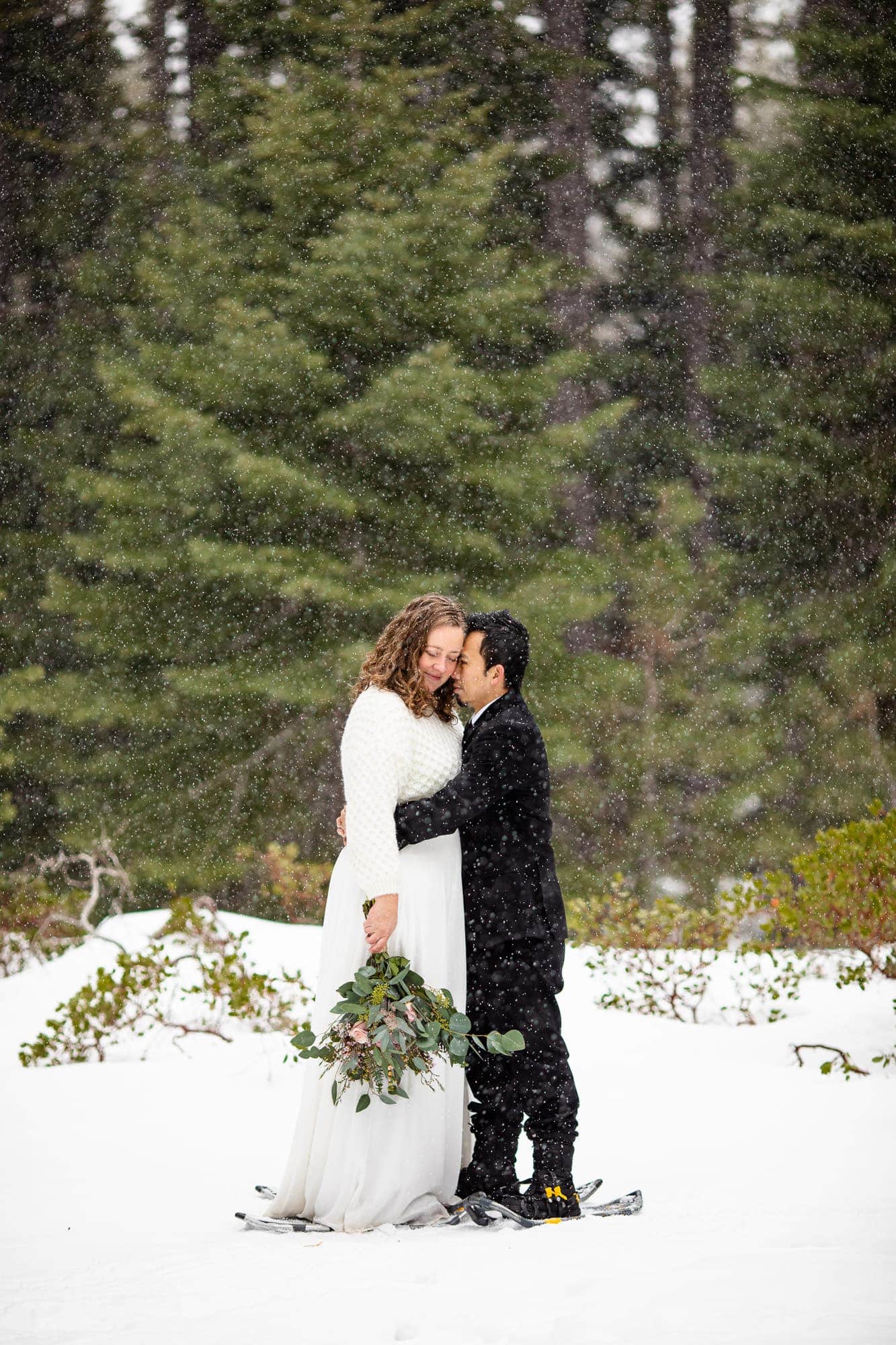 Snowy Tahoe elopement with bride and groom in snowshoes