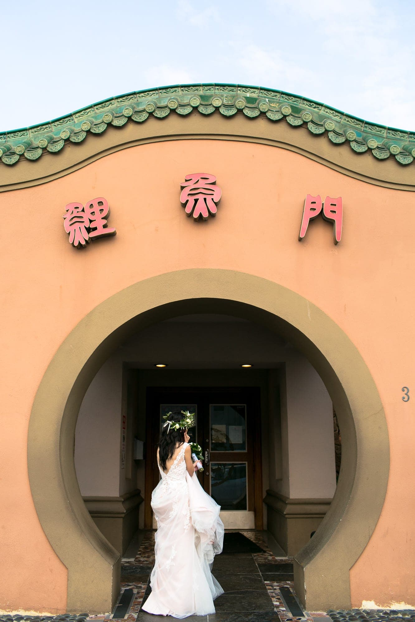 Bride waits outside a Chinese Banquet waiting to be announced to her guests in daly City