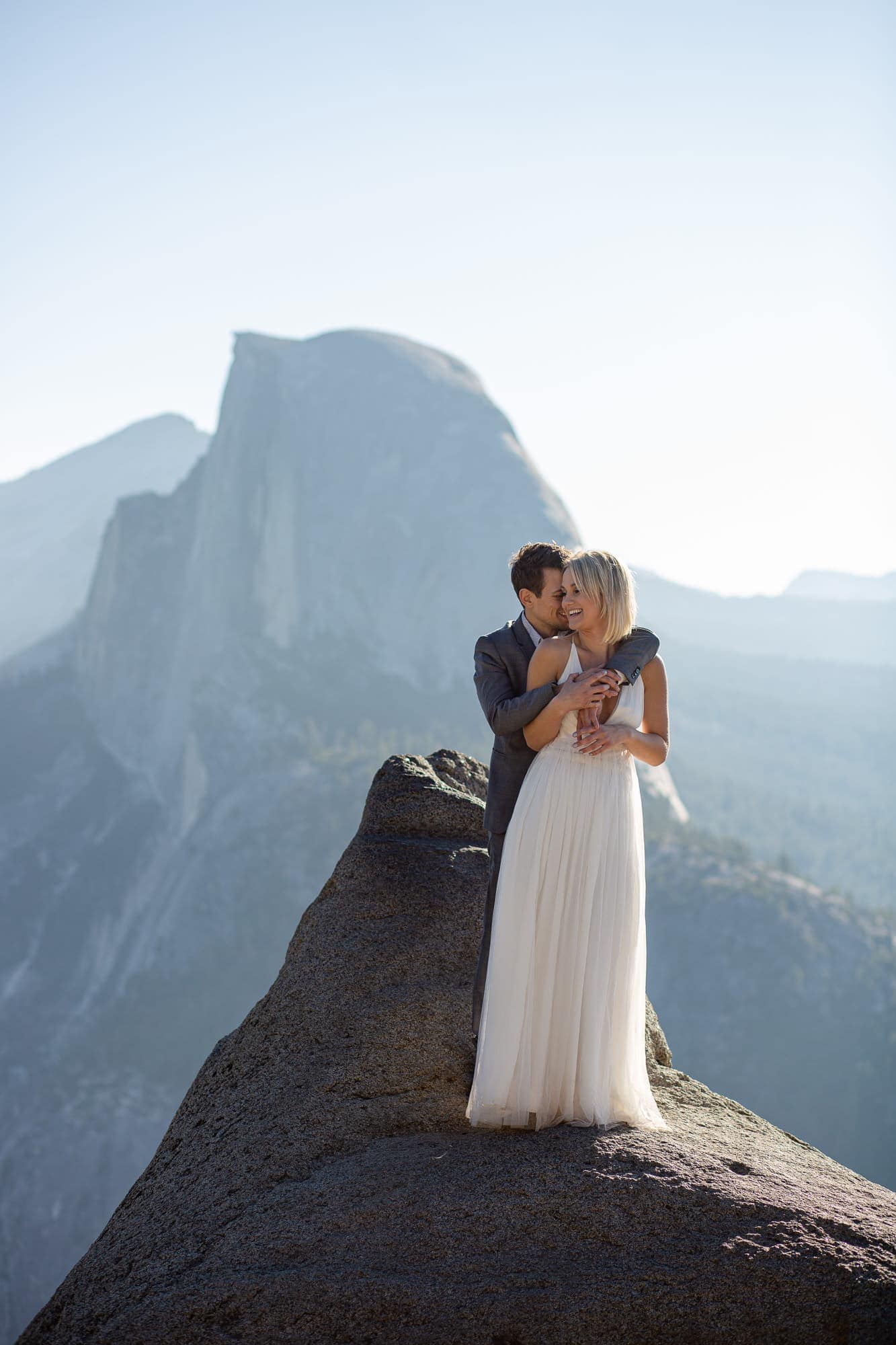Adventure elopement portraits at sunrise at glacier point in Yosemite with Half Dome