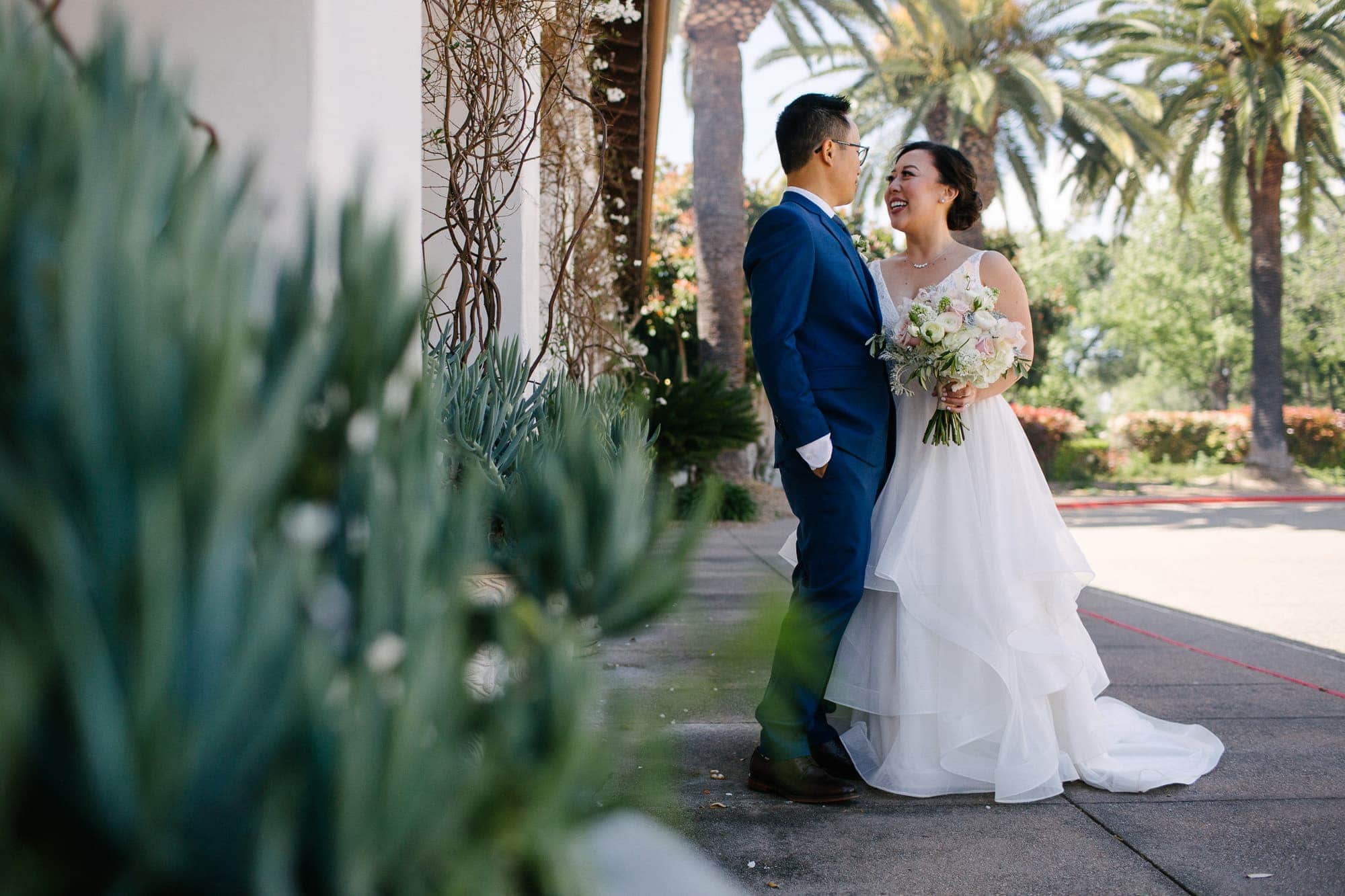Outdoor wedding portraits with palm trees in San Ramon