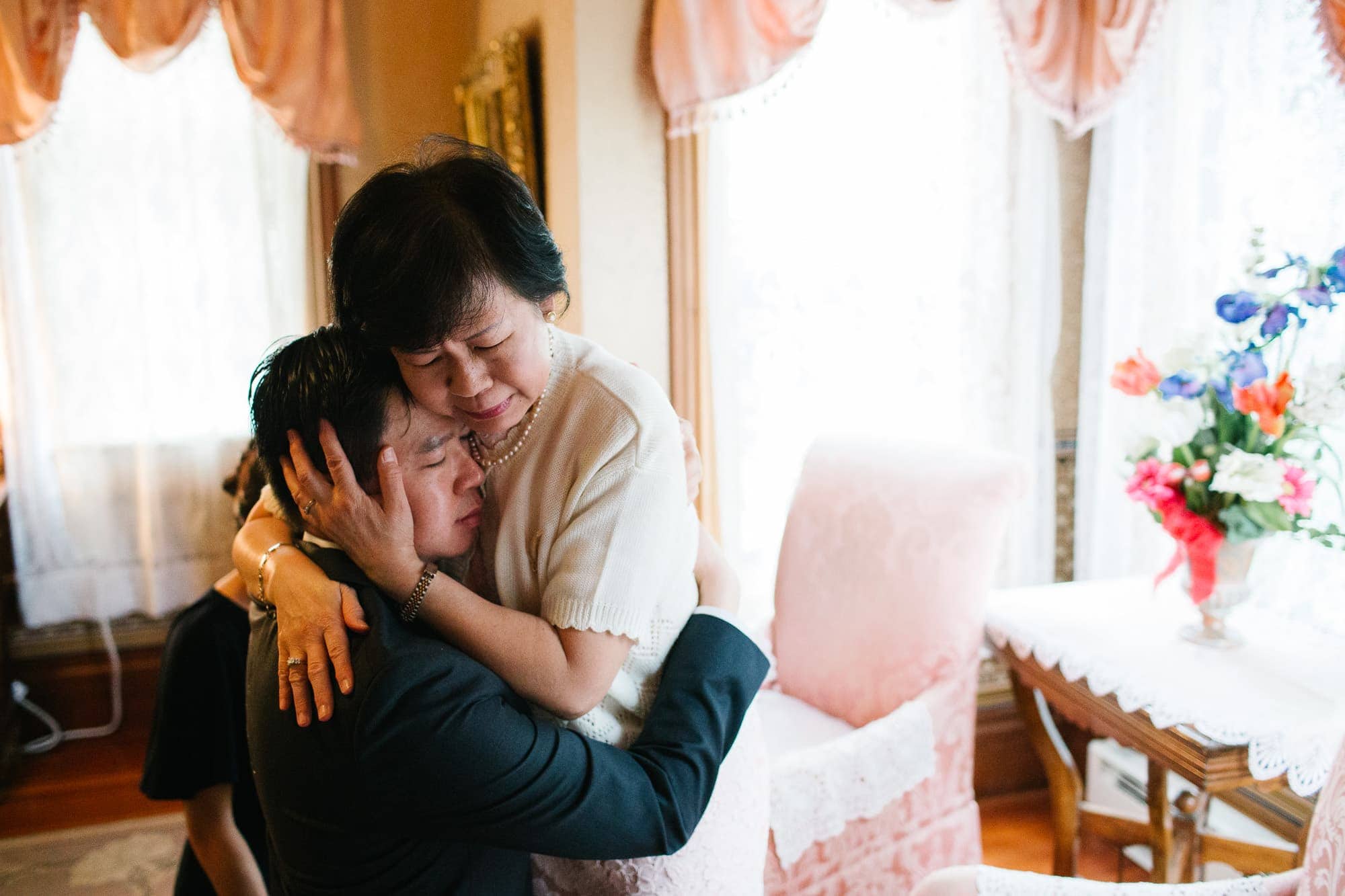 Groom and his mom share a hug after a chinese tea ceremony