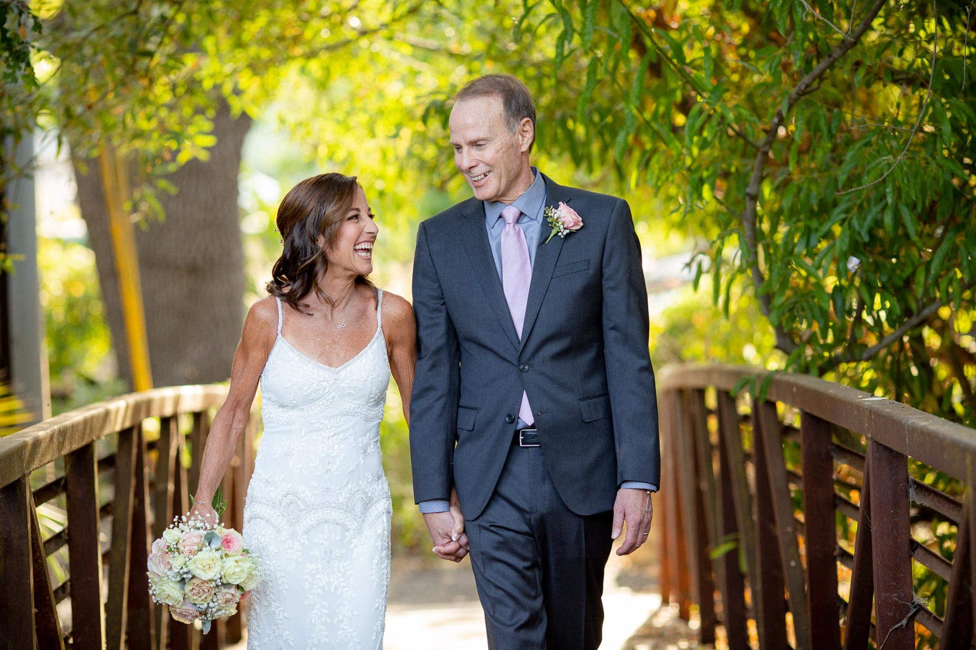 Intimate wedding bride and groom photos on wooden bridge at Hotel Yountville