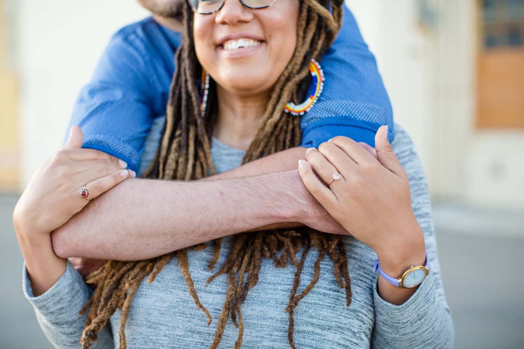Close up of two people hugging focused on the hands