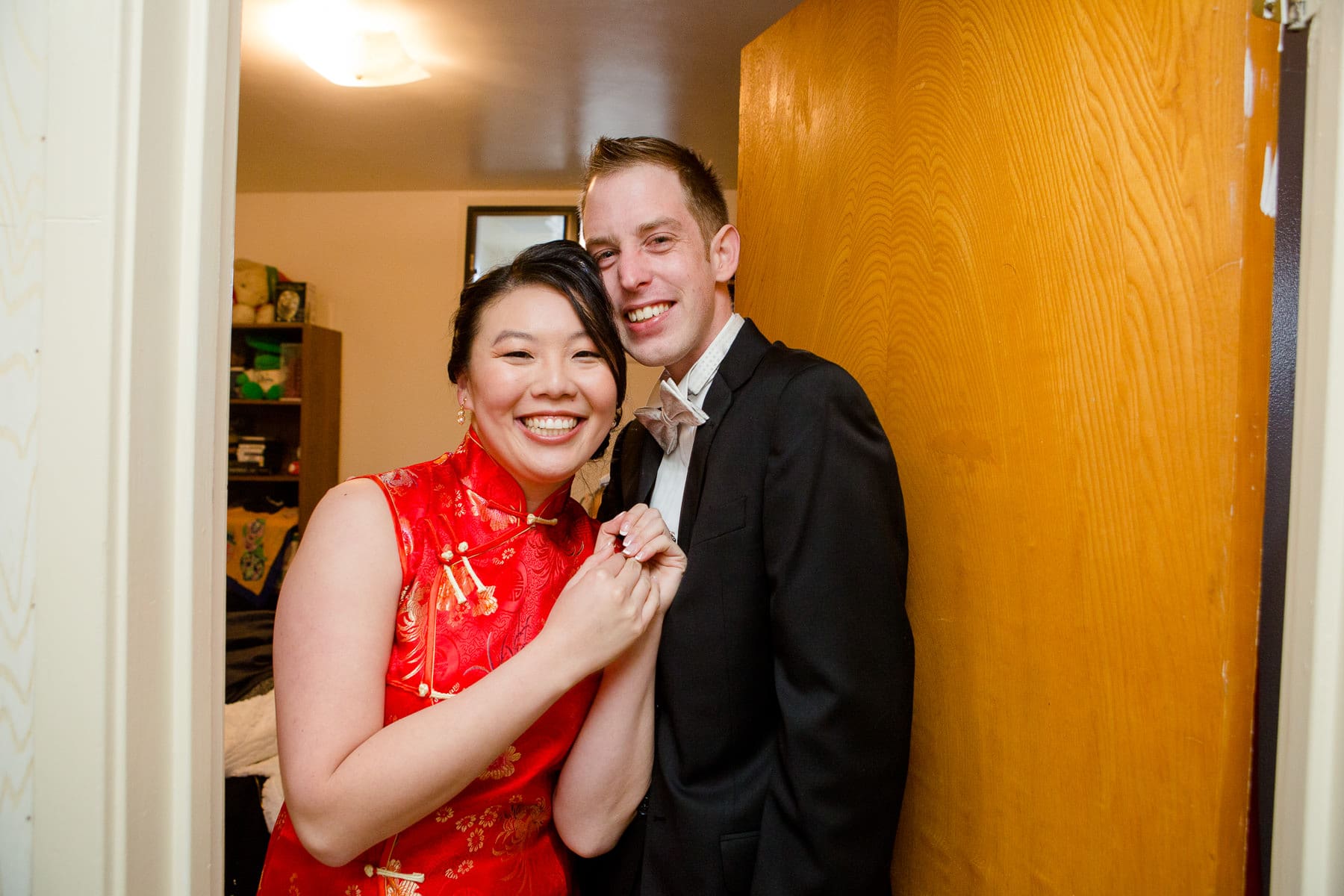 Bride and groom smiling excited to see each other after door games