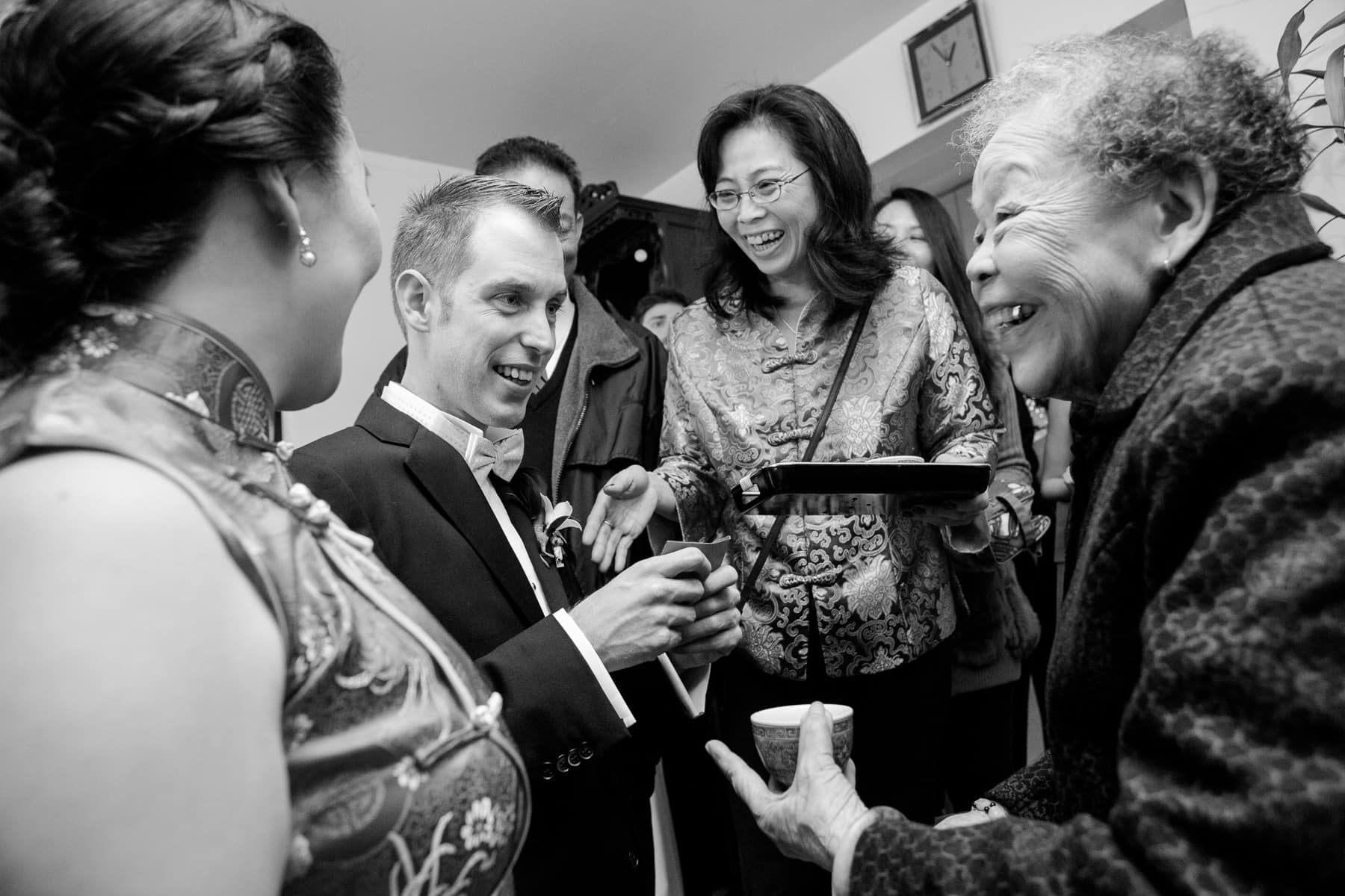 Bride and groom with grandmother during tea ceremony