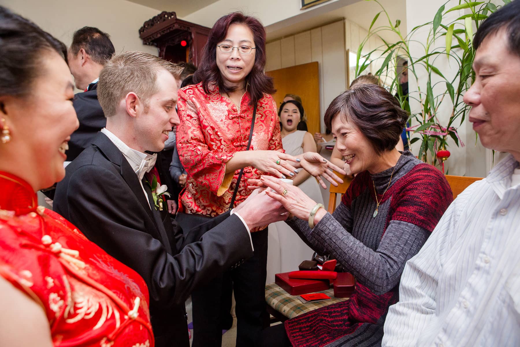 Groom giving mother in law tea during tea ceremony